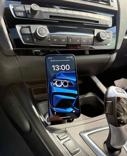 Phone mounted on a car dashboard displaying the time