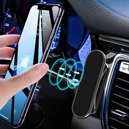 Hand holding a smartphone with a clear screen protector, placed on a car dashboard with a wireless charging pad.